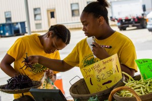 Crew Members selling Purple Amethyst Beans at the Phoenix Hill Farmers' Market.